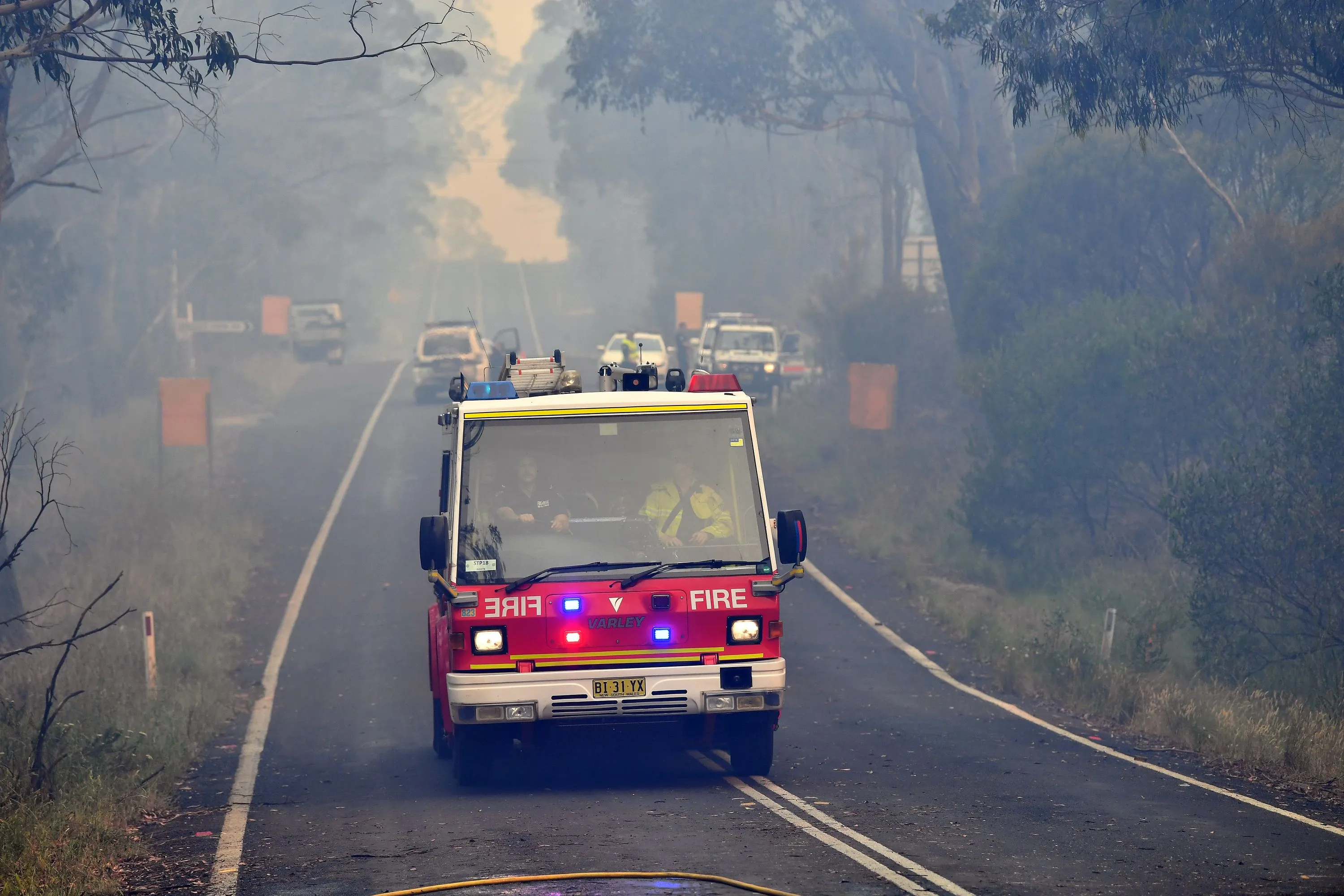 Firetrucks rush to put out a bushfire in Dargan, northwest of Sydney on Dec. 18.
