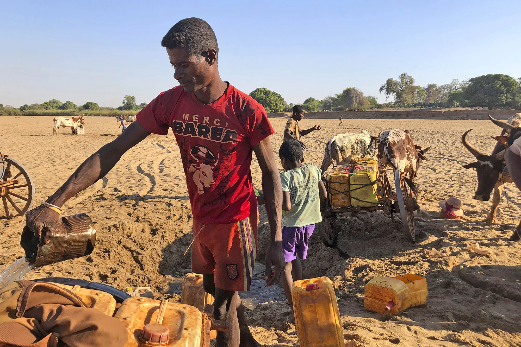 Men dig for water in the dry Mandrare river bed, in Madagascar.