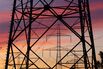 Electricity Pylons And Power Lines Against The Sunset 