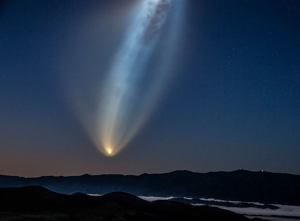 A Falcon 9 rocket with multiple Starlink satellites.