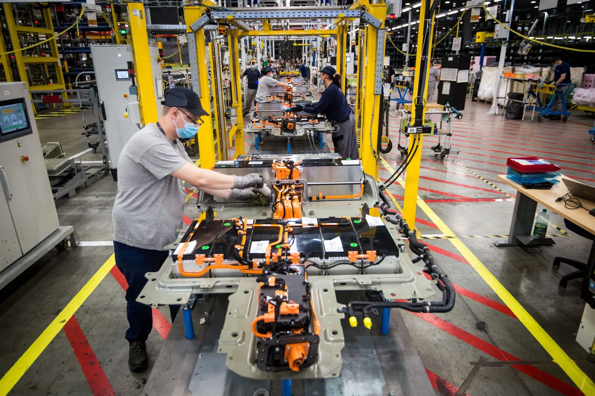 An employee assembles a battery-pack for electric cars on an assembly line in Slovakia. 