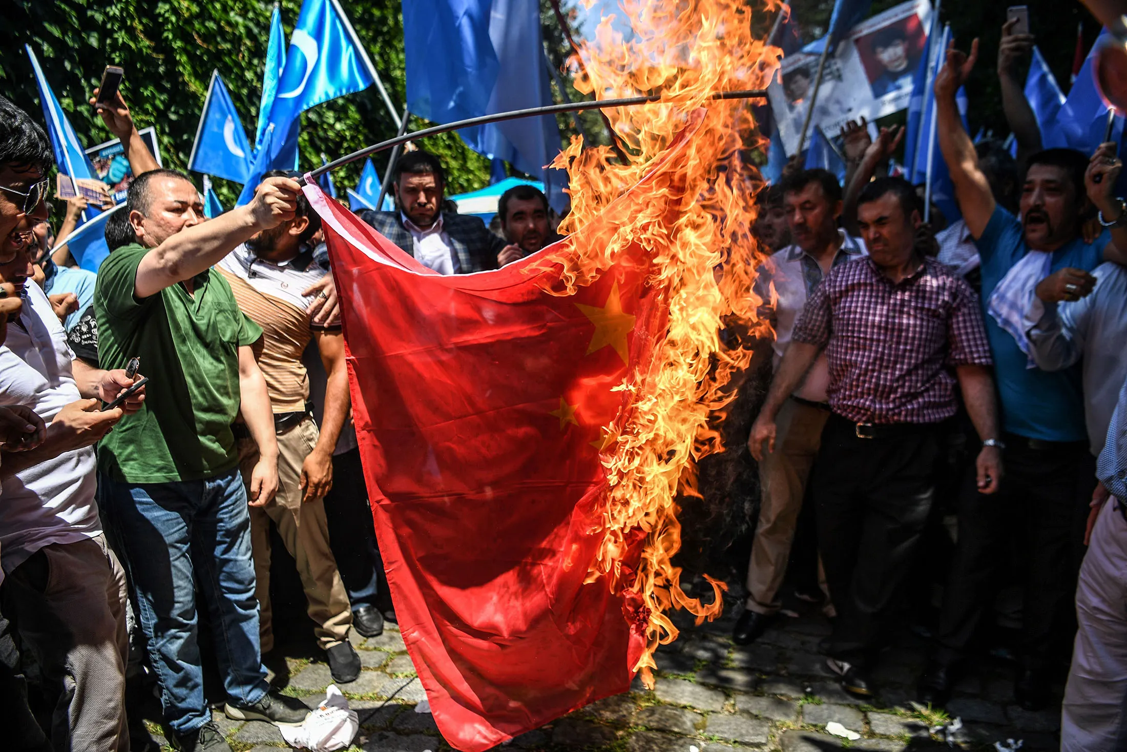 Demonstrators burn a Chinese flag during a protest to denounce China's treatment of ethnic Uighur Muslims during a deadly riot on July 2009 in Urumqi, in&nbsp;Istanbul, on July 5.
