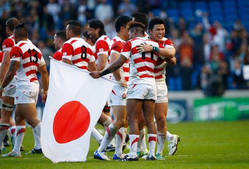 Japanese rugby players celebrate following their upset victory over powerhouse South Africa during the 2015 Rugby World Cup Pool B match in Brighton, United Kingdom on Sept. 19, 2015.