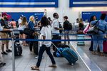 Travelers At LaGuardia Airport As Trump Travel Ban Goes Into Effect
