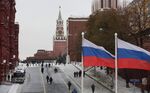 Two Russian Federation flags fly on a road leading to the Lenin mausoleum on Red Square in Moscow, Russia, on Thursday, Nov. 10, 2016. Russia is realistic about limits on the prospects for an immediate improvement in relations with the U.S. after President-elect Donald Trump takes office, according to President Vladimir Putin’s spokesman.
