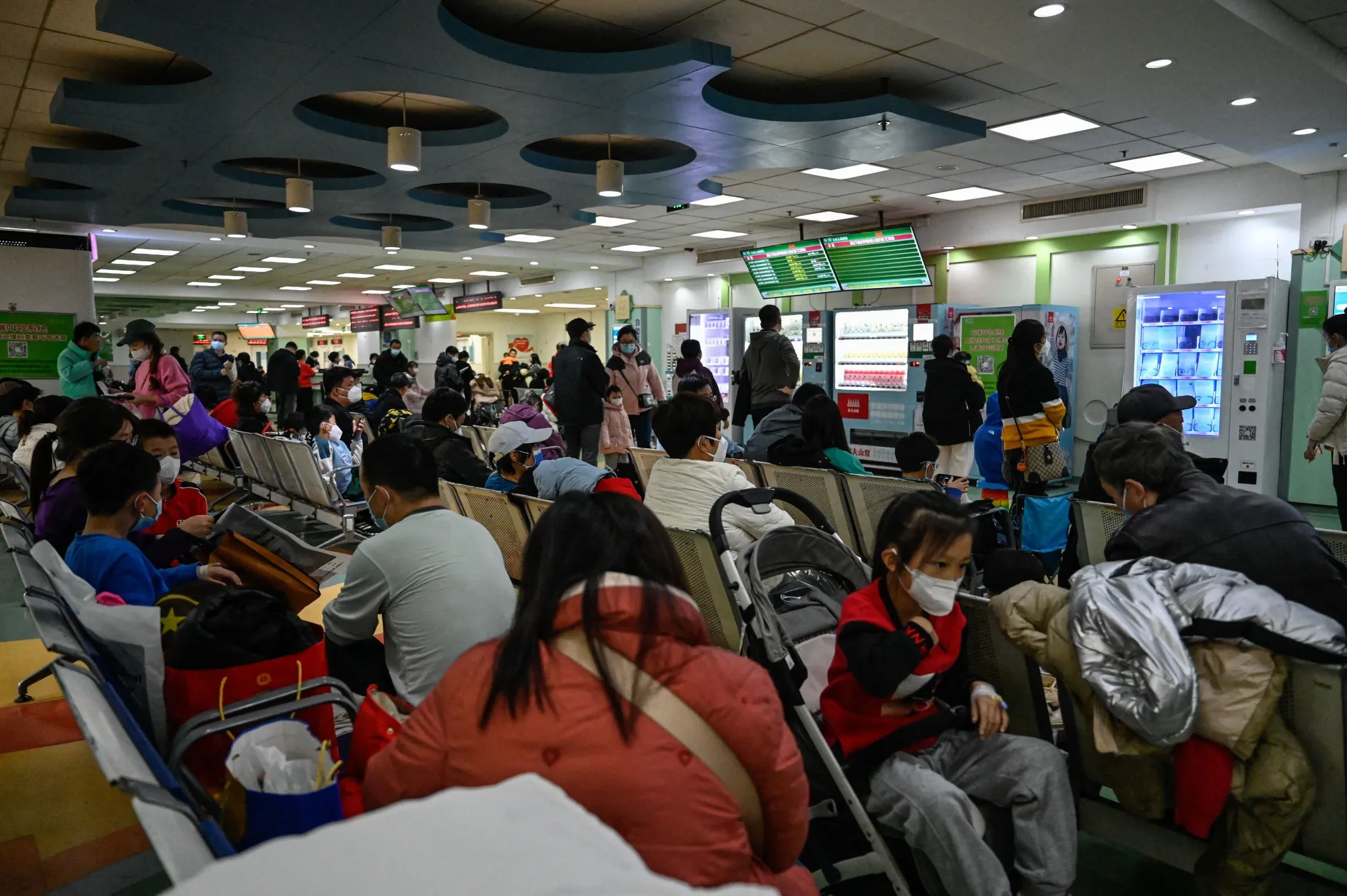 Parents and children wait at an outpatient area at a children hospital in Beijing.&nbsp;