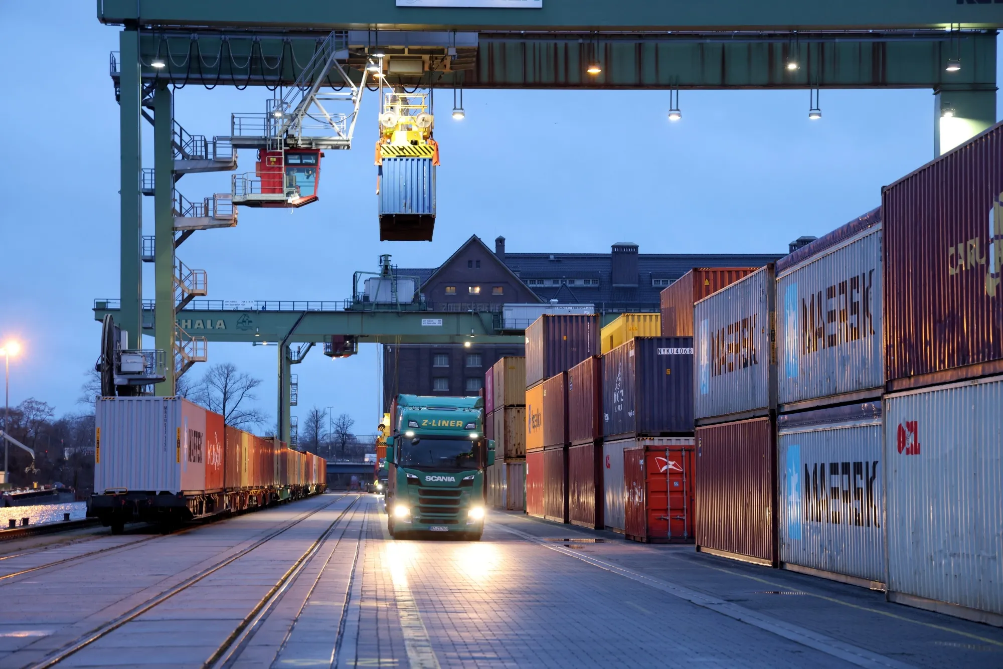 Haulage trucks and a freight train at the Behala inland port in Berlin.