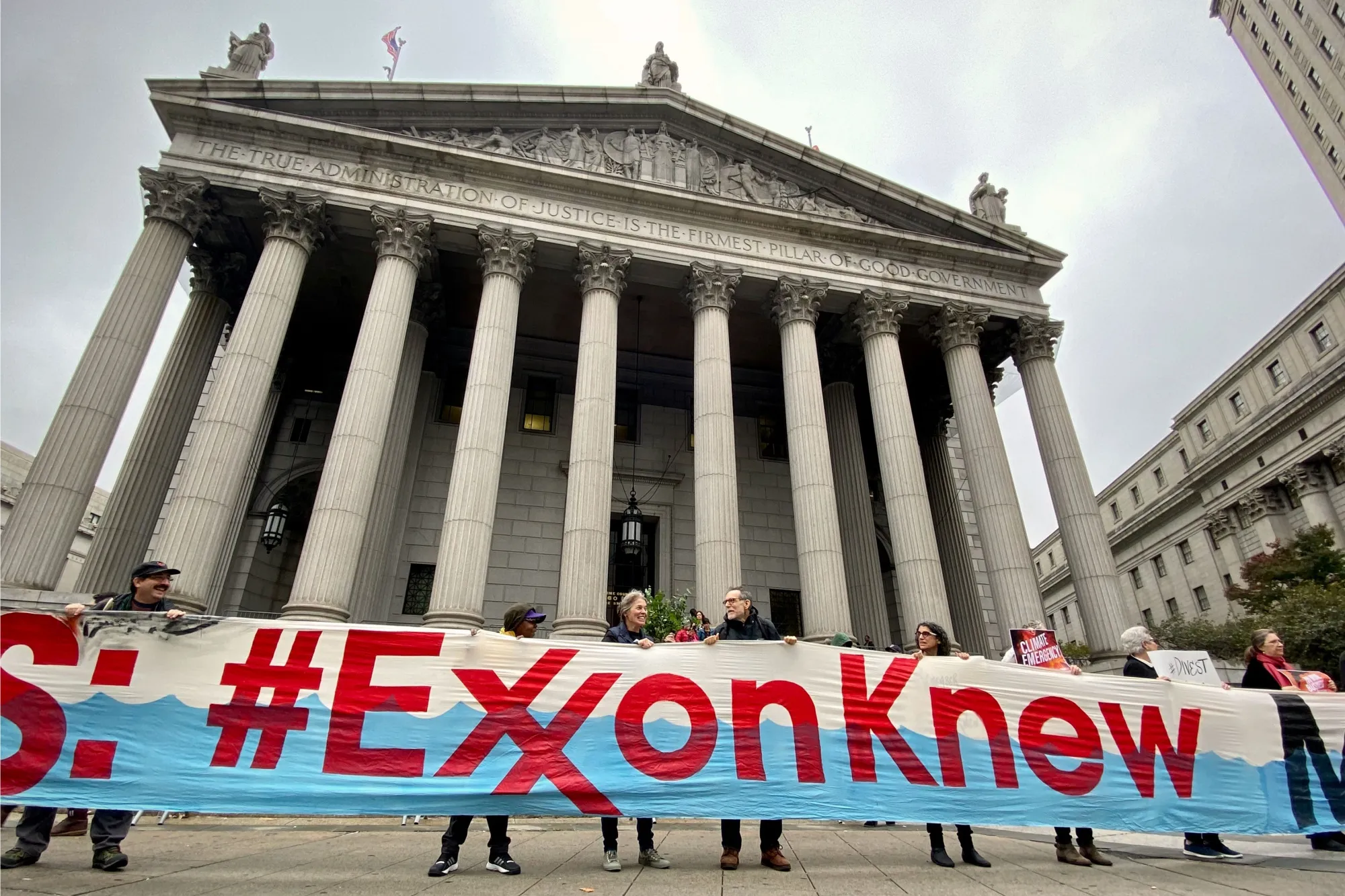 Protesters gather outside New York state court in Manhattan Oct. 22 as trial begins in the state’s lawsuit against Exxon Mobil.