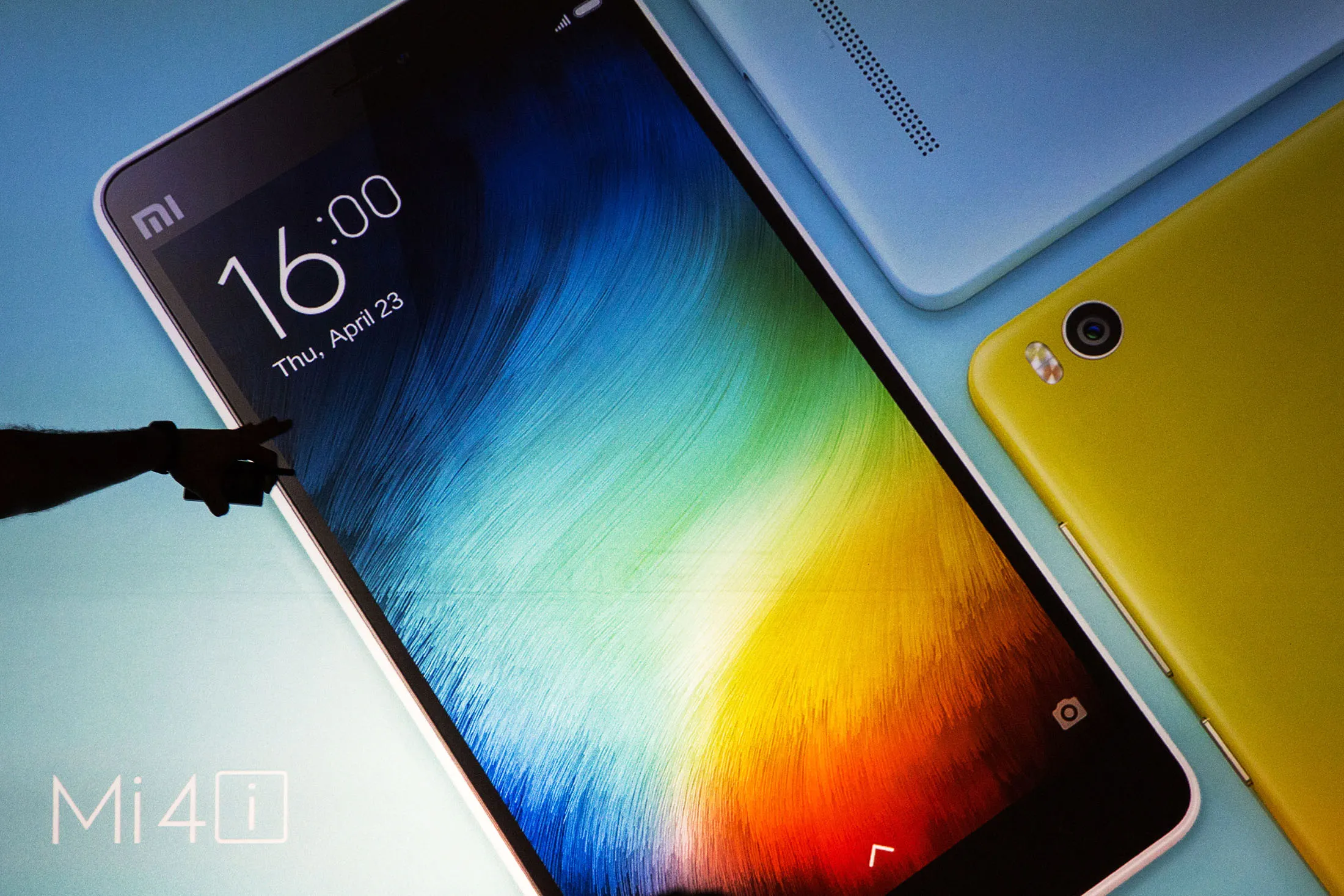 Xiaomi Mi 4i smartphones are displayed on a screen during a news conference in Hong Kong, China.
