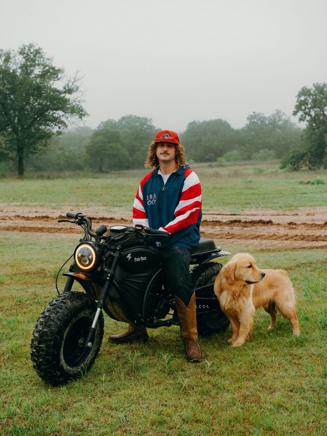 Josh Farahzad on an electric bike and his dog Dezik outside. 
