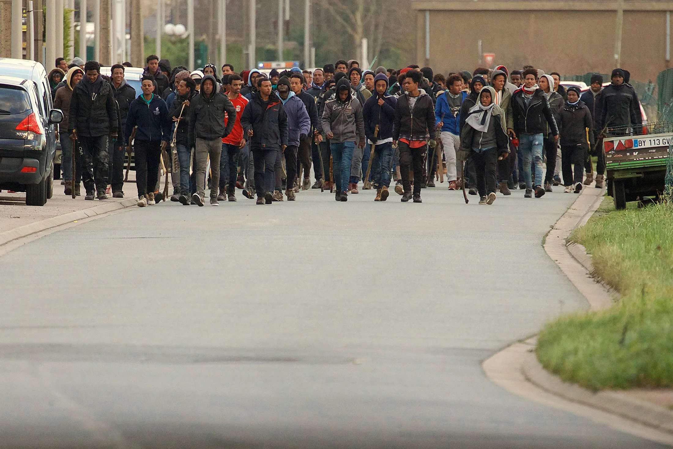 Migrants carrying sticks march in the streets of Calais on&nbsp;&nbsp;Feb. 1.
