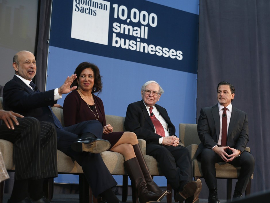 In 2013, then-CEO of Goldman Sachs Lloyd Blankfein (far left) and Berkshire Hathaway CEO Warren Buffett (second from right) joined Detroit car dealer Pamela Rodgers and Quicken Loans founder Dan Gilbert to discuss bringing Goldman Sachs' 10,000 Small Businesses initiative to Detroit.