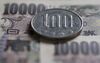A Japanese 100 yen coin and 10,000 yen banknotes are arranged for a photograph in Tokyo, Japan, on Monday, June 20, 2016.