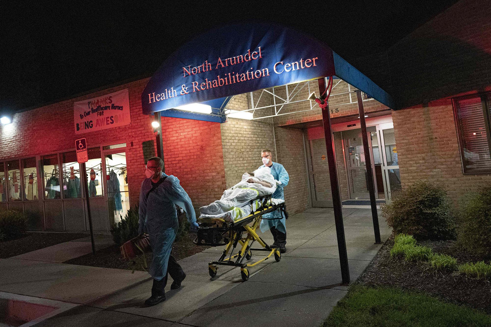 Firefighters and paramedics transport a potential COVID-19 patient to a hospital on April 29.