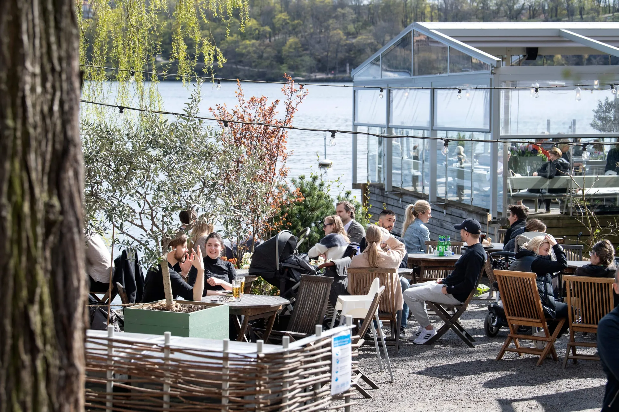 People sit in the spring sun at an outdoor restaurant in Stockholm, Sweden on April 26.