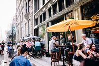 People sit outside during happy hour at the Oscar Wilde bar in New York, on Wednesday, June 10, 2020. New York streets got a little more congested this week as the city entered the first phase of its reopening from the coronavirus-imposed lockdown.