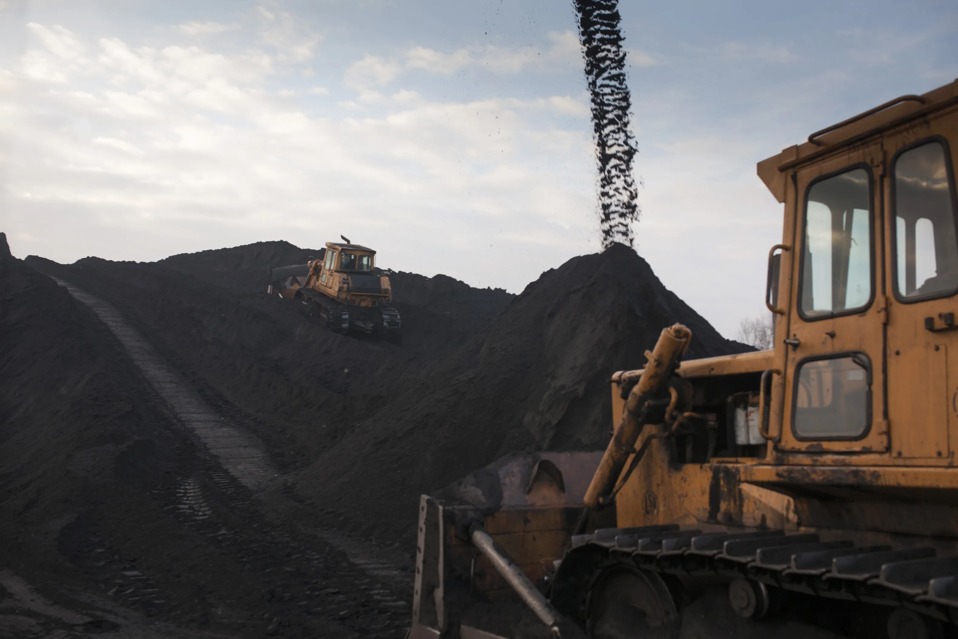 Bulldozers arrange stores of coking coal in Slaska, Poland.