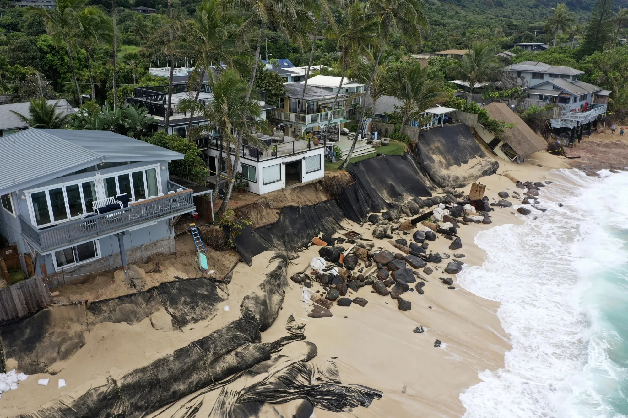A home, right, after it collapsed on a beach experieincing&nbsp;erosion in Haleiwa, on Feb. 28, 2022.&nbsp;&nbsp;