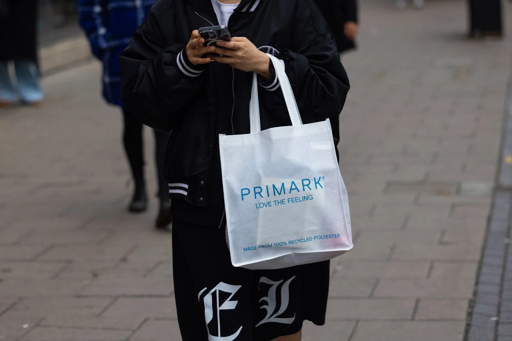 A shopper with a bag from a Primark fashion store in London.