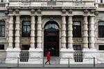 A pedestrian passes the headquarters of Assicurazioni Generali in Trieste, Italy, Tuesday, March 7, 2006. Shares of Assicurazioni Generali SpA, Italy's largest insurer, rose to their highest in more than four years, extending a 7 percent jump yesterday after the company said it will buy out some of its foreign units and repurchase stock.