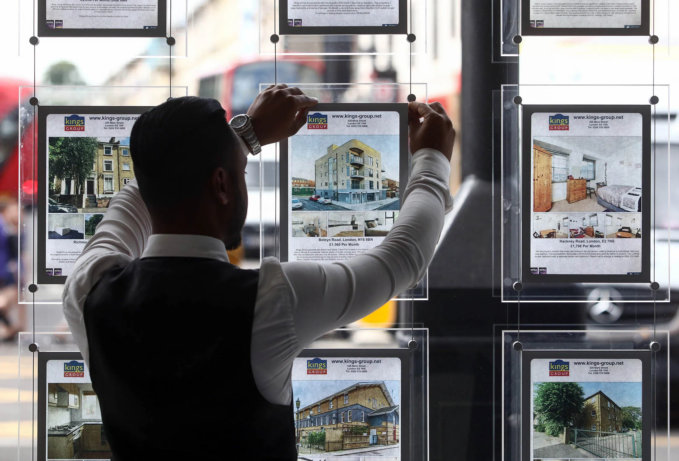 An employee places an advert for a residential house for sale into an estate agent's window in this arranged photograph in the Hackney borough of London, U.K., on Thursday, July 21, 2016. London's seven-year housing boom may be about to end after the U.K. voted to leave the European Union.
