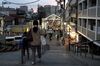 Pedestrians and shoppers walk through the Yanaka Ginza shopping street at dusk in the Yanesen district of Tokyo, Japan, on Tuesday, March 19, 2019. Japan's stock indexes on March 25 are set for their biggest declines since Christmas Day as a global batch of indicators stoked concern over faltering economic growth.