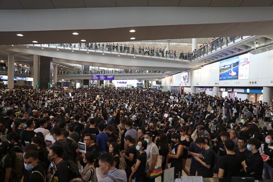 Stranded, Squeezed and Seething as Hong Kong Airport Shuts Down