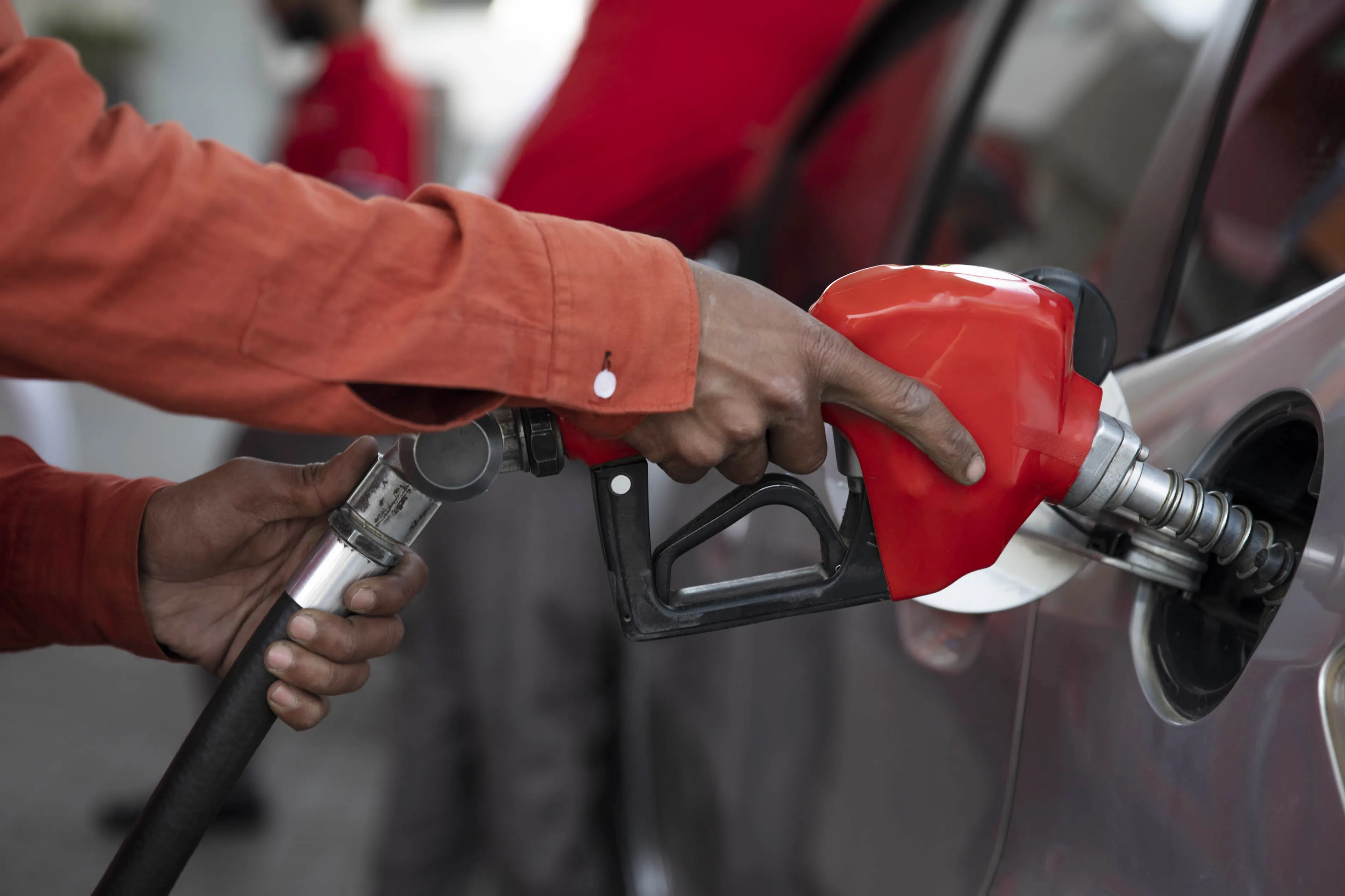 A worker pumps fuel into a car at a gas station in Lahore, Pakistan.