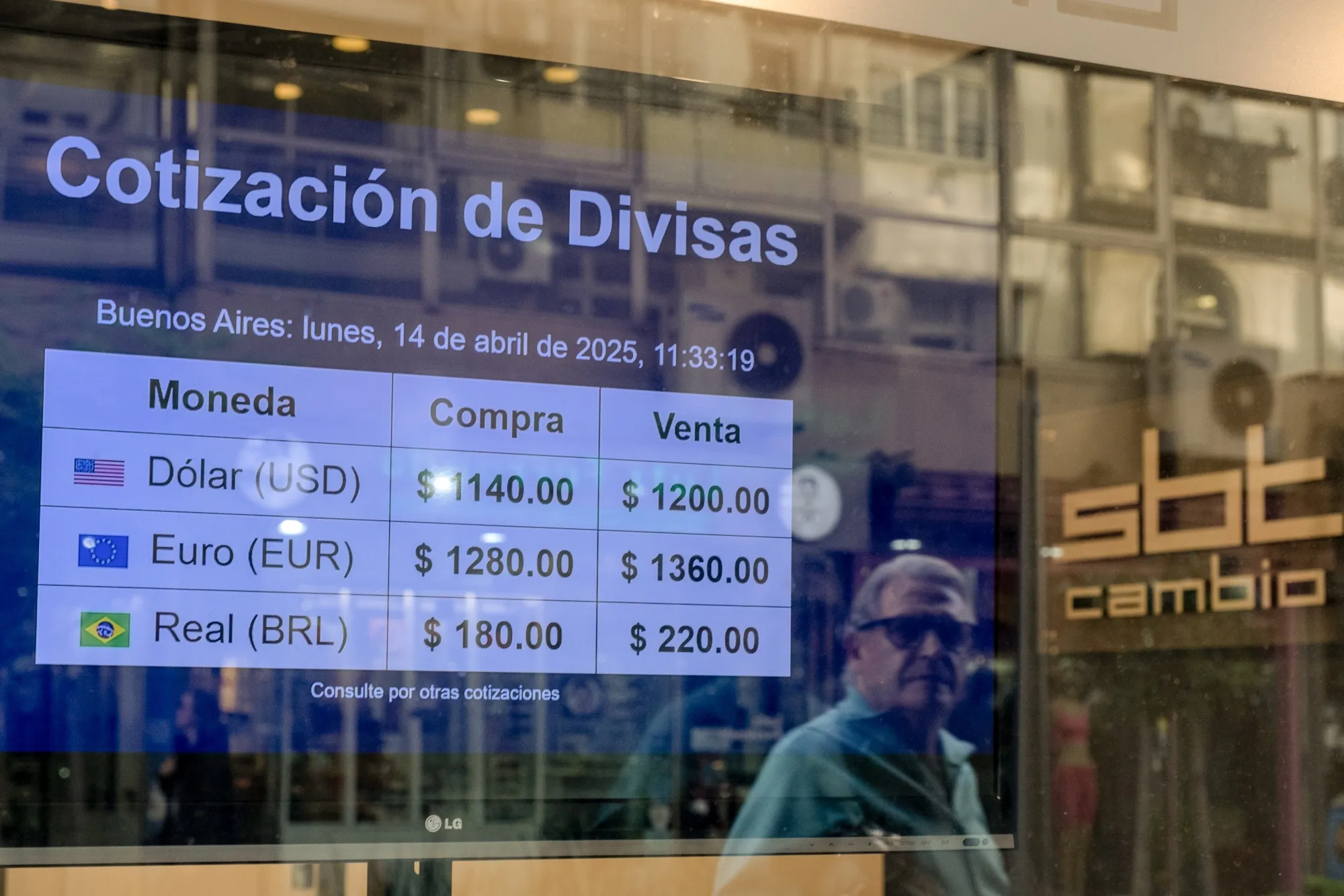 Exchange-rate information is posted in Buenos Aires after currency controls were eased on April 14.
