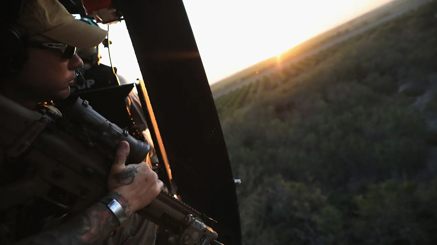 U.S. Customs and Border Protection agents fly near the U.S.-Mexico border on a helicopter patrol on Oct. 18, 2016 near McAllen, Texas.
