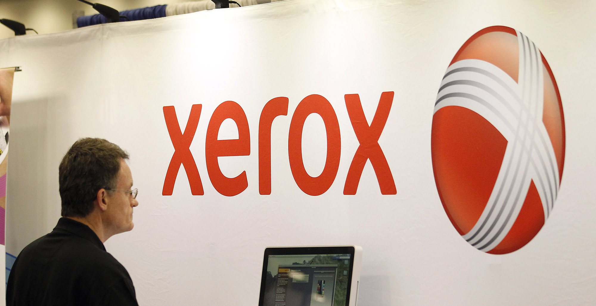 The Xerox logo is displayed at their booth at a conference.