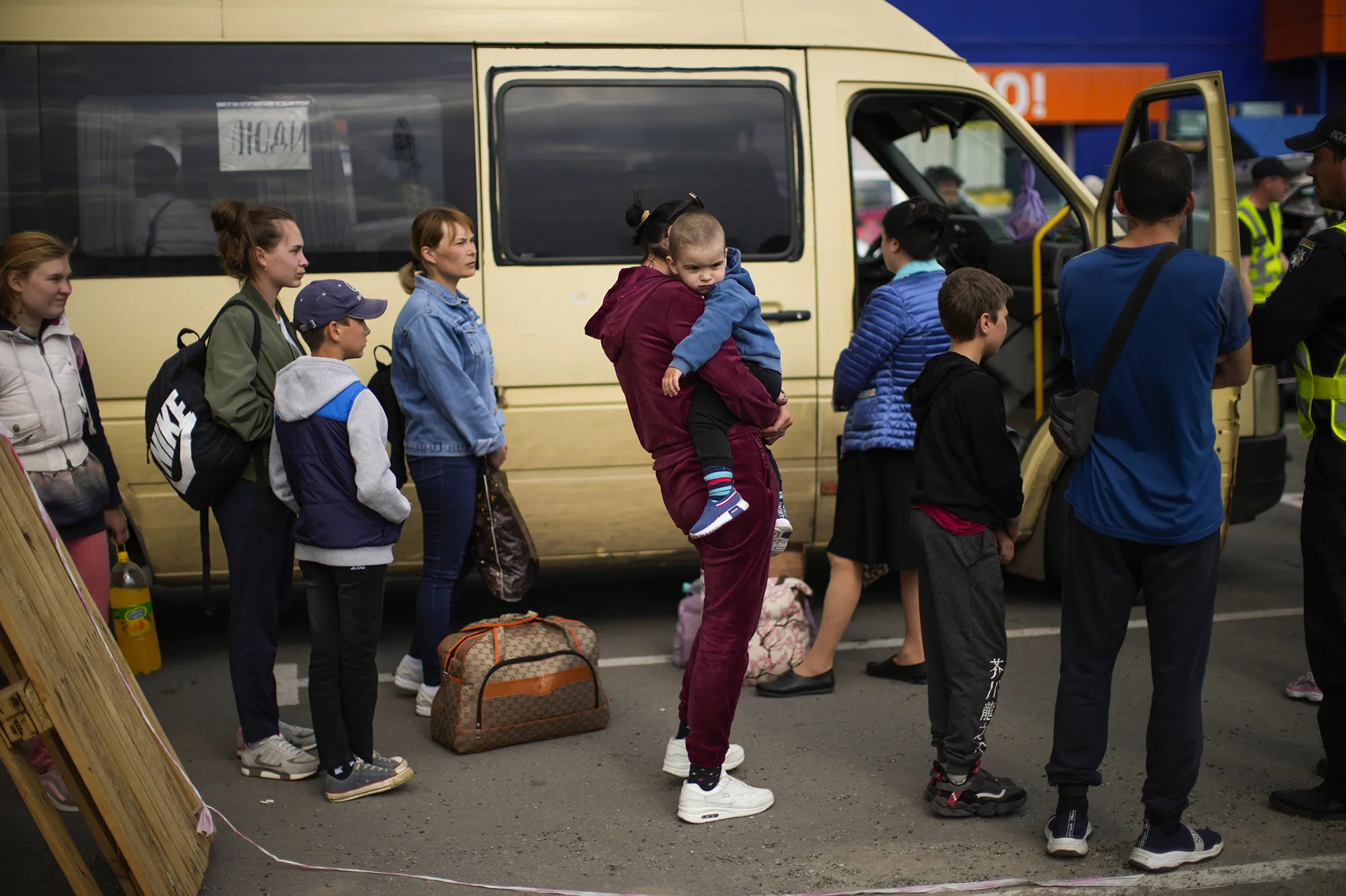 People wait to be processed upon their arrival at a reception center for displaced people in Zaporizhzhia, Ukraine, on&nbsp;May 2.