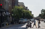A man pushes a stroller while walking on Broughton Street in Savannah, Georgia. The city is offering incentives to tech workers willing to relocate.&nbsp;