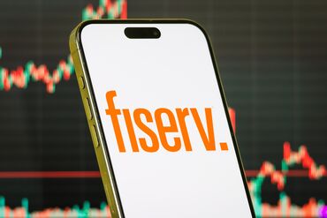 Fiserv Inc. logo on smartphone with stock market chart background