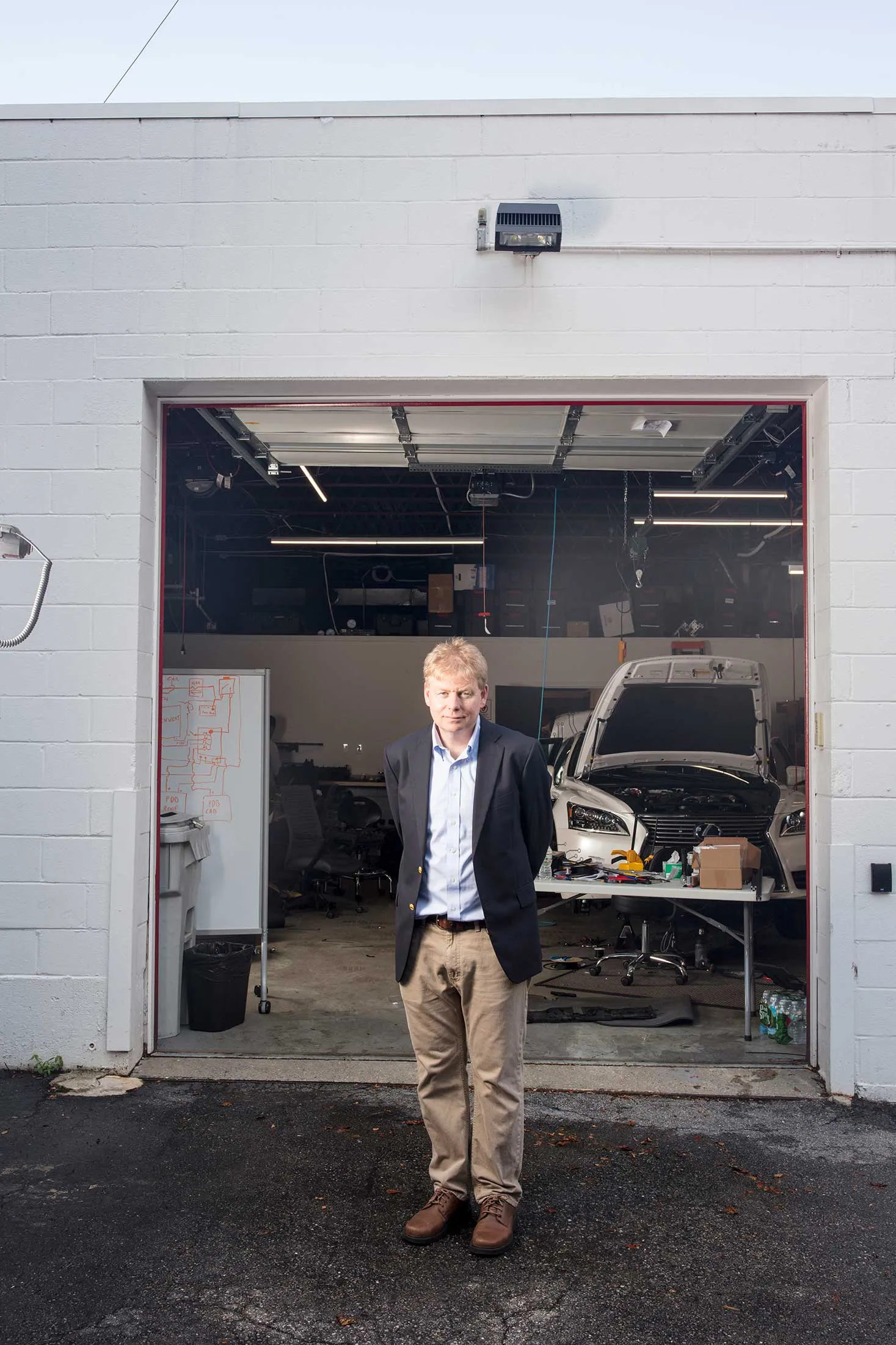 John Leonard at the Toyota Research Institute’s MIT garage. Behind him is the institute’s tricked-out Lexus.