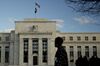 A pedestrian walks past the Marriner S. Eccles Federal Reserve building in Washington, D.C., U.S., on Tuesday, Dec. 15, 2015. E