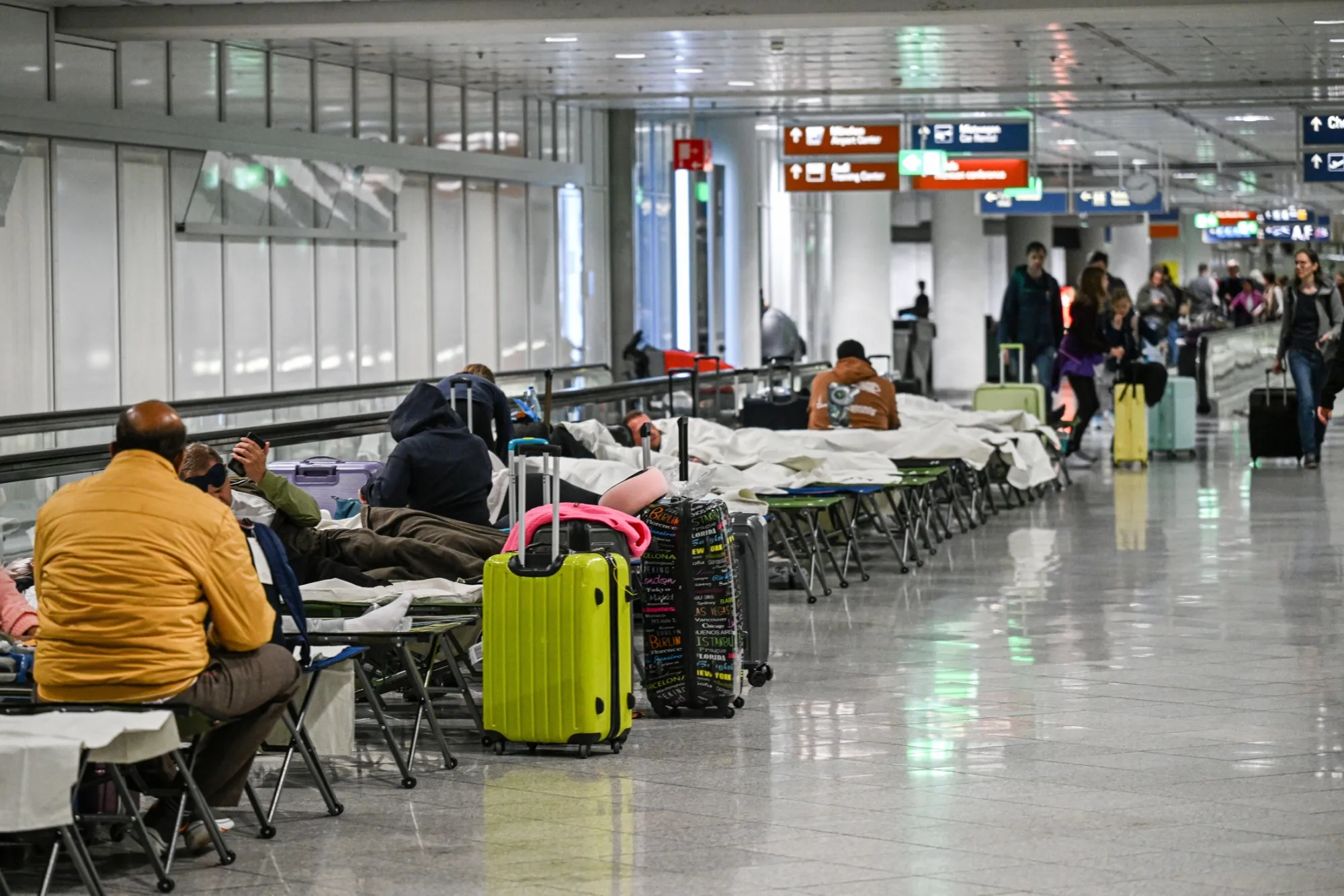 Travelers wait following disruped servces at Munich Airport on Oct. 3.