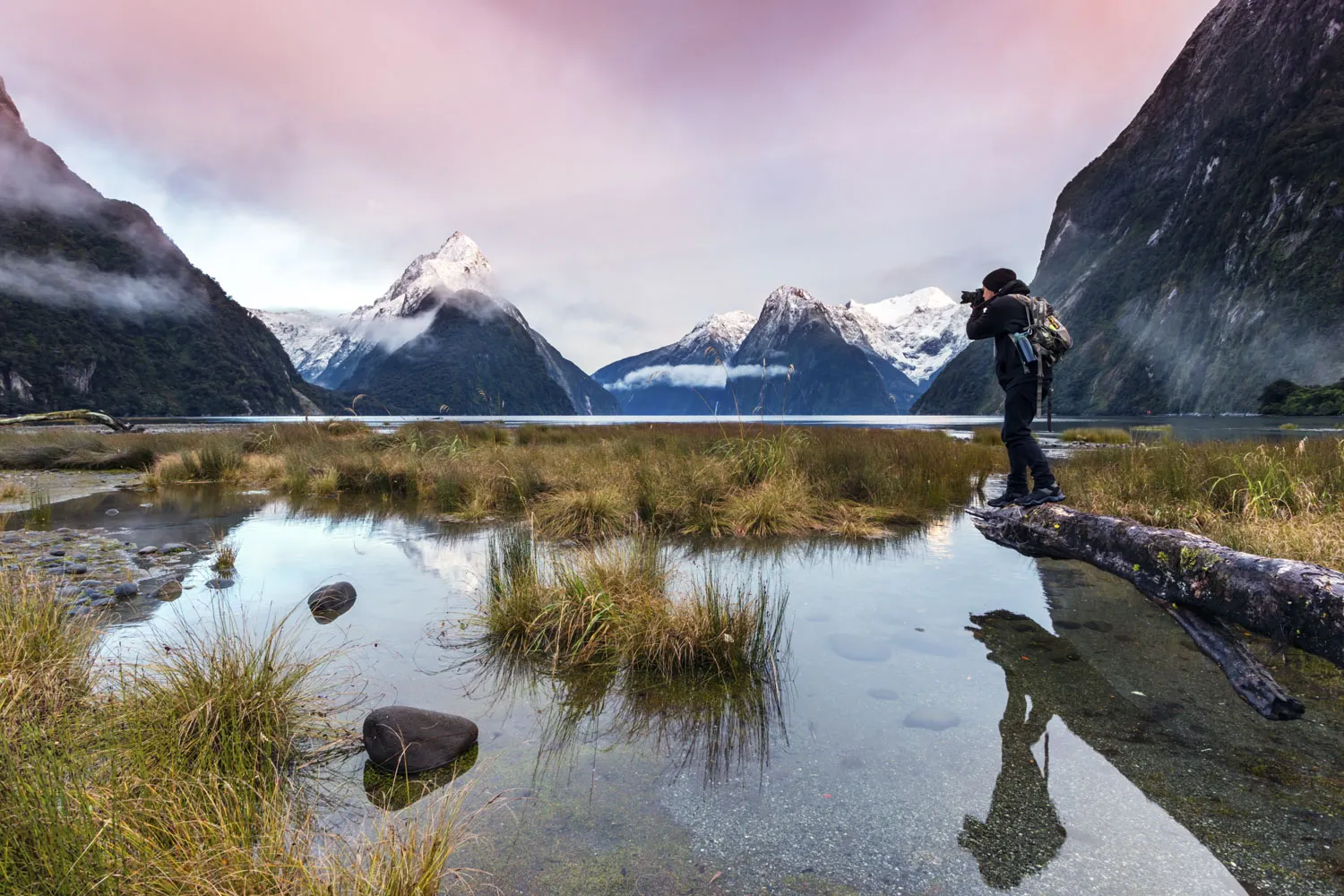 A man shoots&nbsp;the sunset at Milford Sound in&nbsp;Fiordland National Park, Southland, New Zealand.