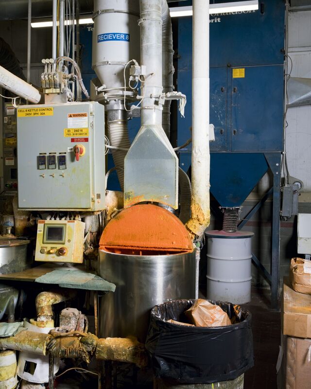 Hot paraffin wax is piped into blend kettles, where workers pour in premeasured bags of pigment. The company goes through almost 450,000 pounds of wax every five days.