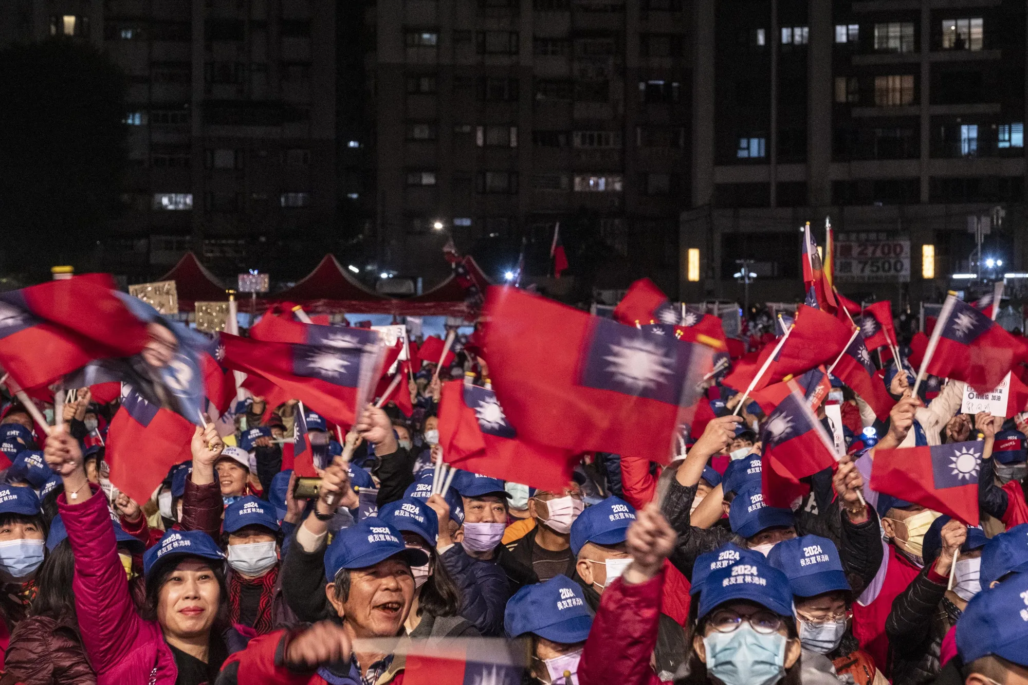 Attendees wave Taiwanese flags during a campaign event for Hou Yu-ih in Keelung, Taiwan.