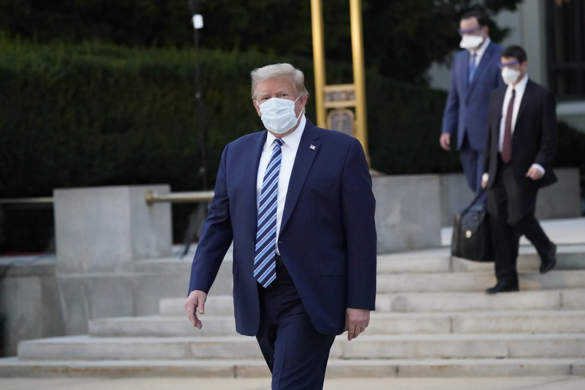 Donald Trump wears a protective mask while walking out of Walter Reed National Military Medical Center on Oct. 5.