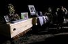 Relatives and friends stand next to the coffins of Rhonita Miller and four of her children, who were killed during the ambush in Mexico four years ago.