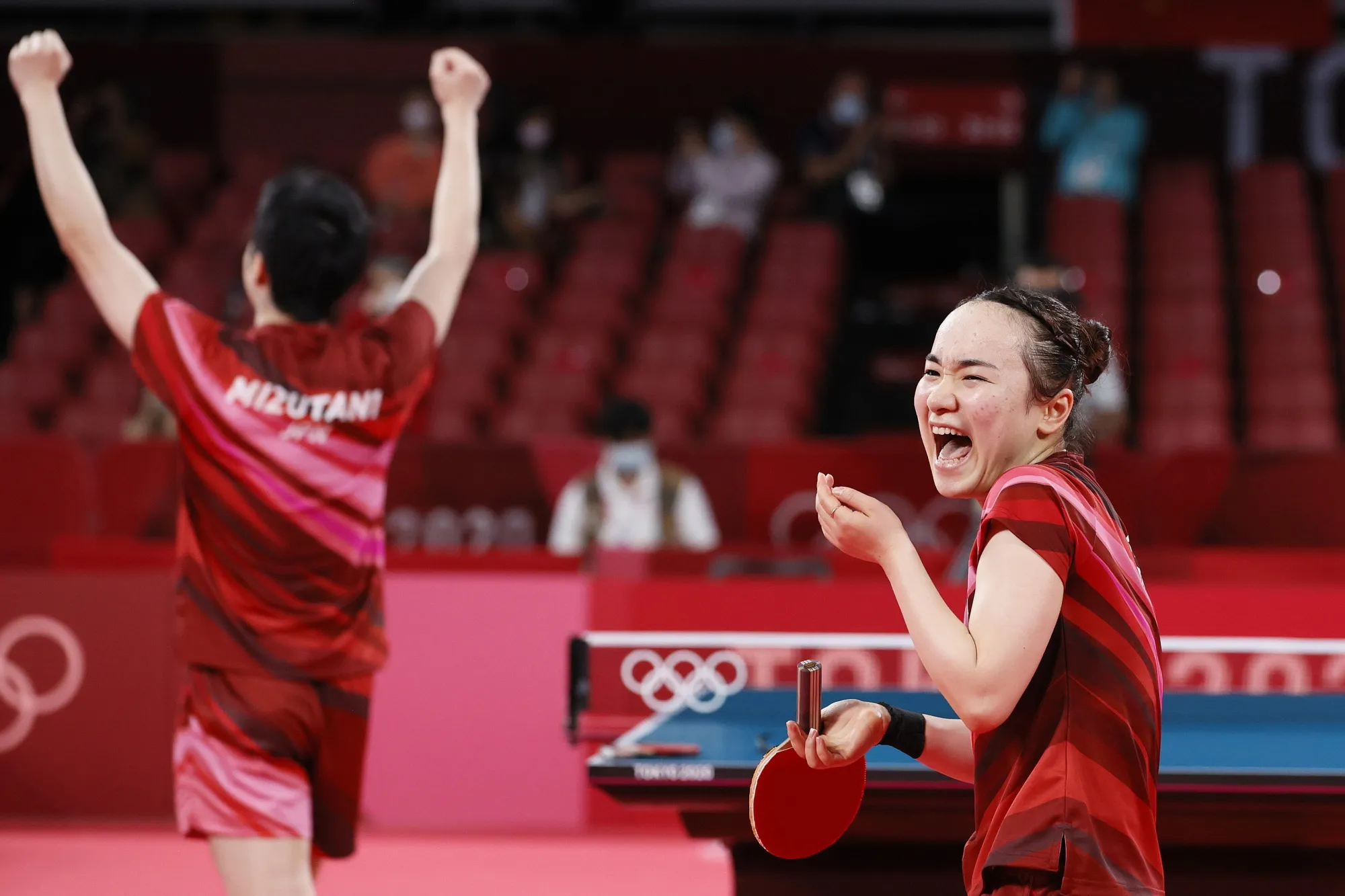 Mima Ito and Jun Mizutani&nbsp;react after winning their Mixed Doubles Gold Medal match on July 26.
