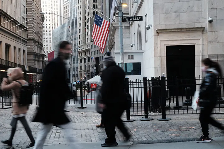 People walk by the New York Stock Exchange&nbsp;in New York.