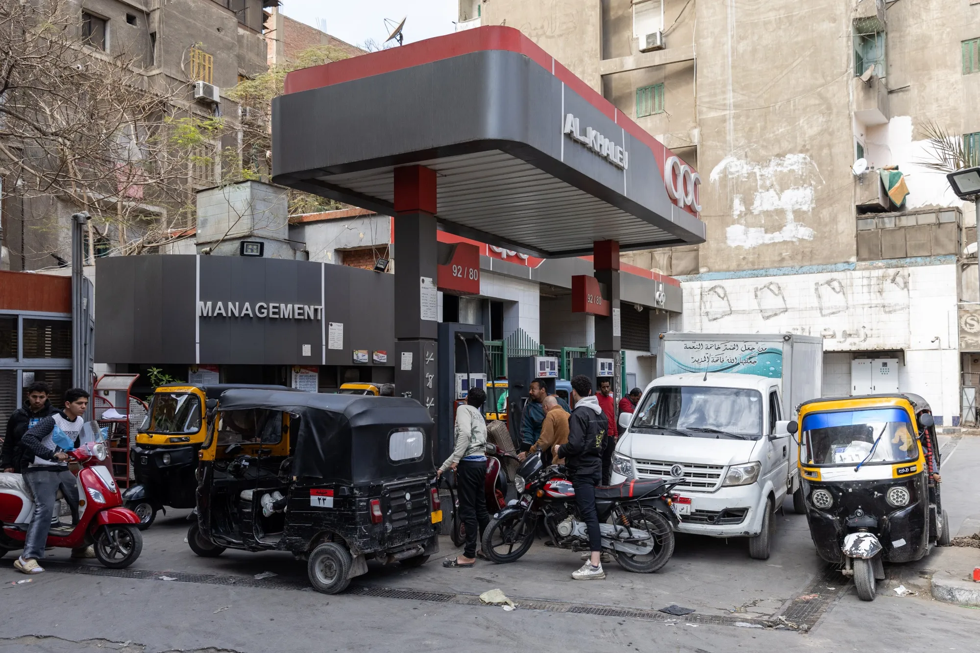 Customers refuel vehicles at a gas station, operated by CPC-Egypt, in Cairo.