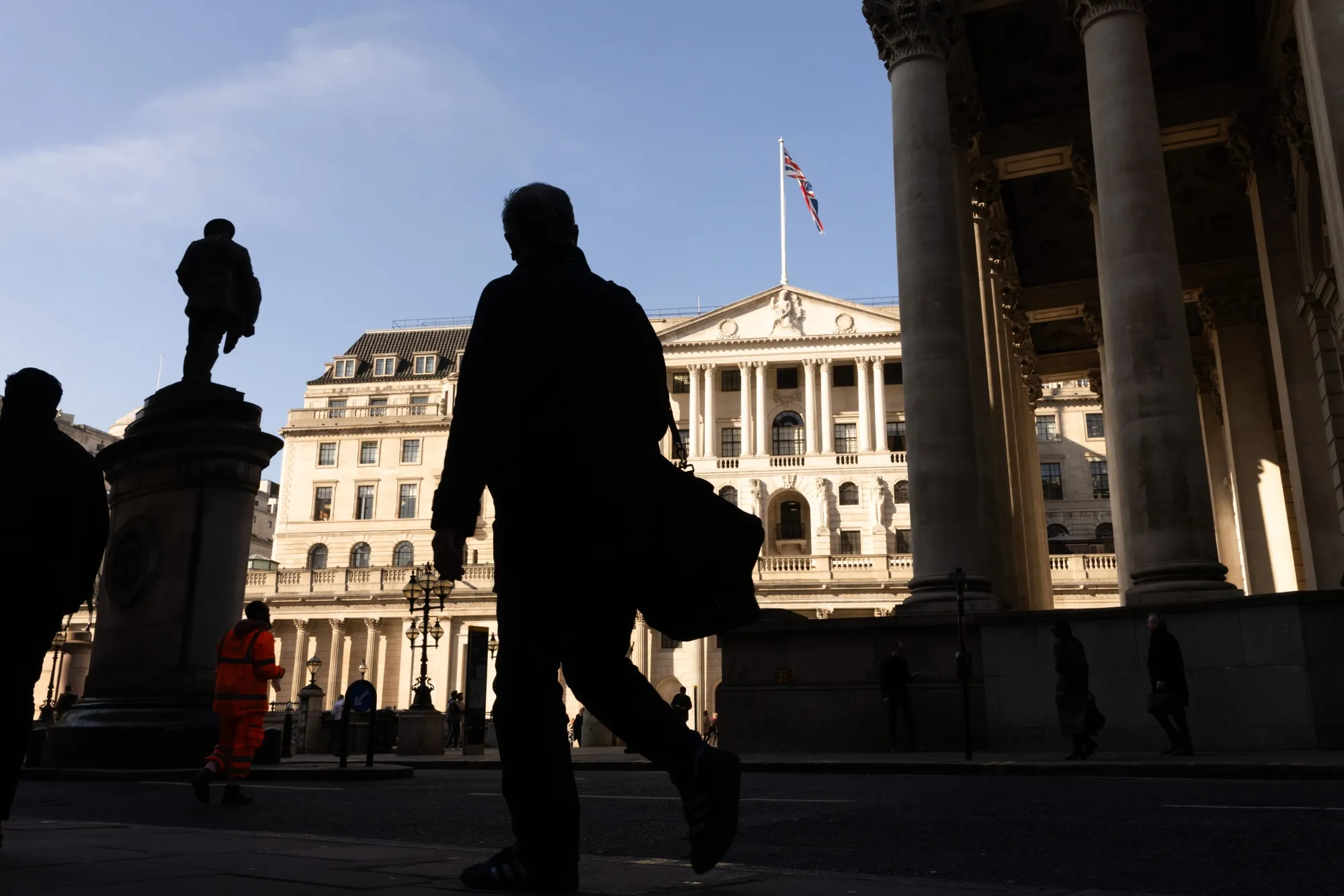 Pedestrians pass the Bank of England in London.