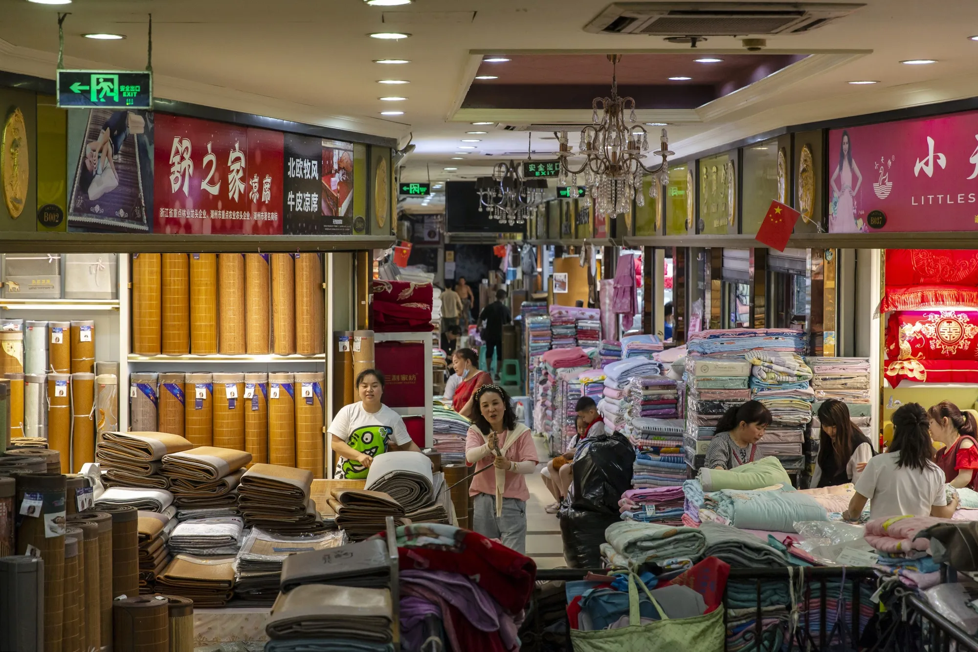 Vendors wait for customers at fabric stores in Chongqing, China, on June 1.