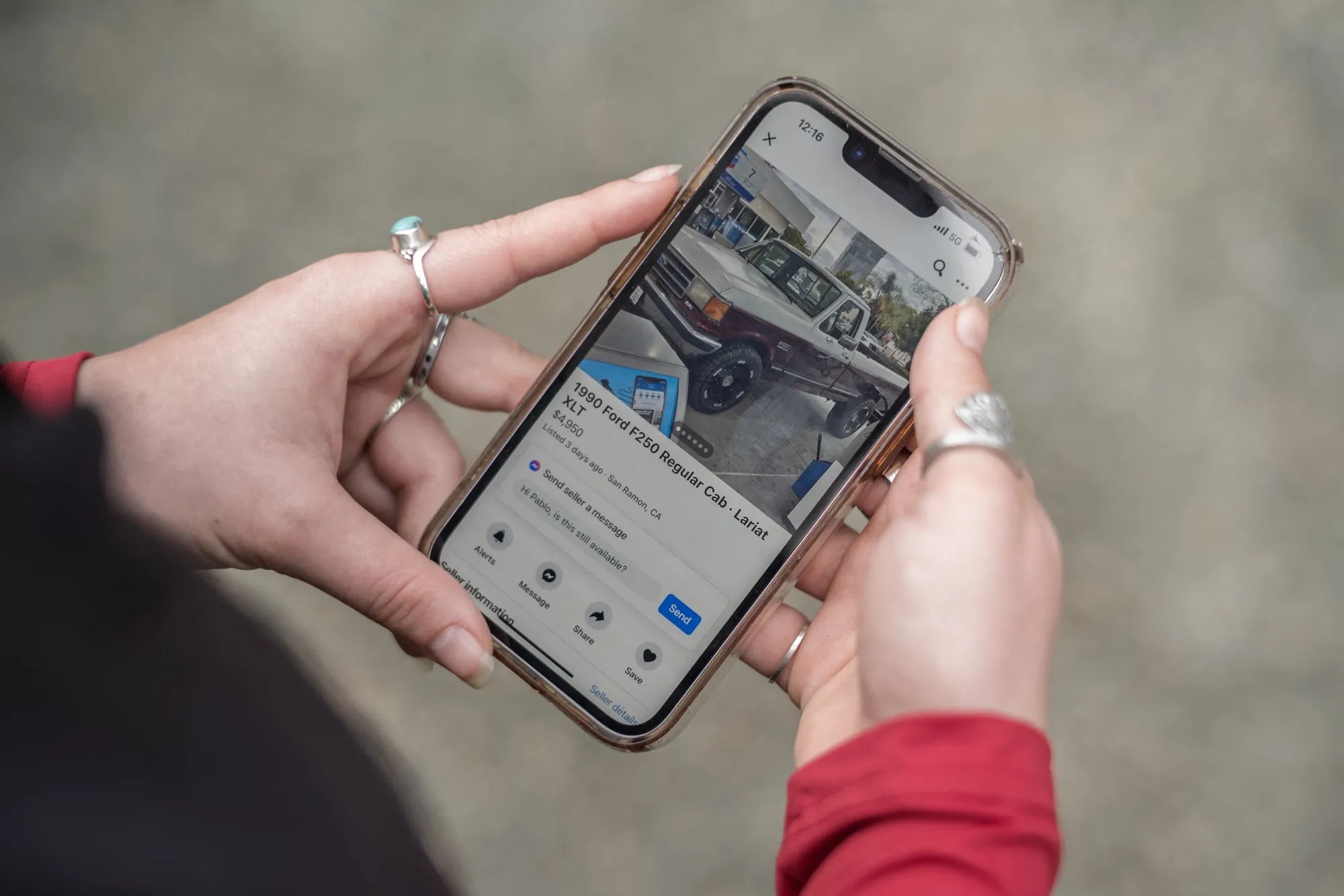 A woman looks at a vehicle for sale on&nbsp;Facebook marketplace.