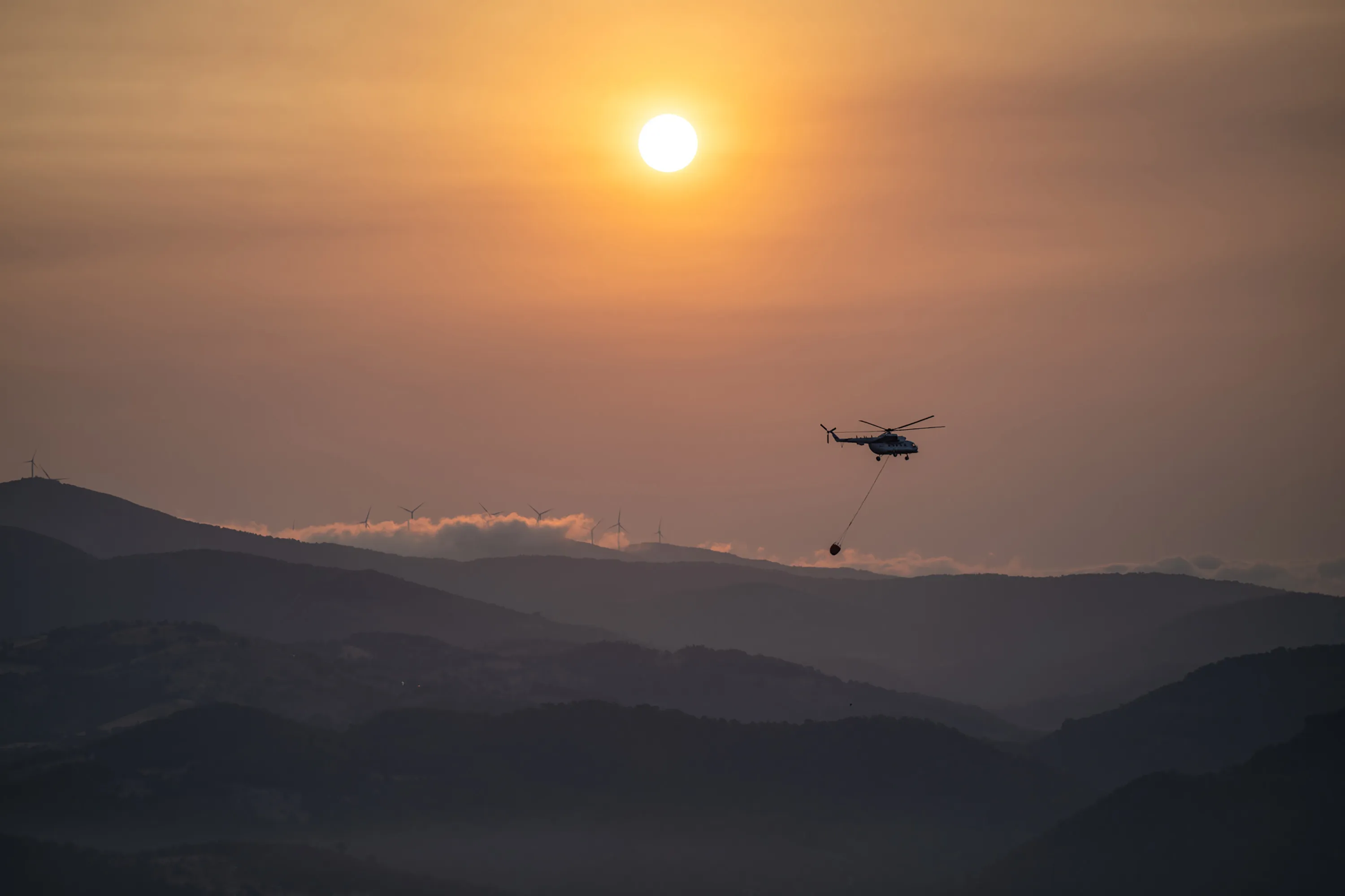A firefighting helicopter drops water on a fire near Kayadere Village in Canakkale, Turkey,&nbsp;on Aug. 24.