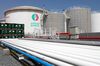 An ENOC-branded oil storage tank stands near pipework at the Emirates National Oil Co. lubricants and grease manufacturing plant in Fujairah, United Arab Emirates, on Monday, March 12, 2012. ENOC, as Dubai's government-owned refiner is known, will expand the plant's capacity to 250,000 tons a year by 2014, it said.